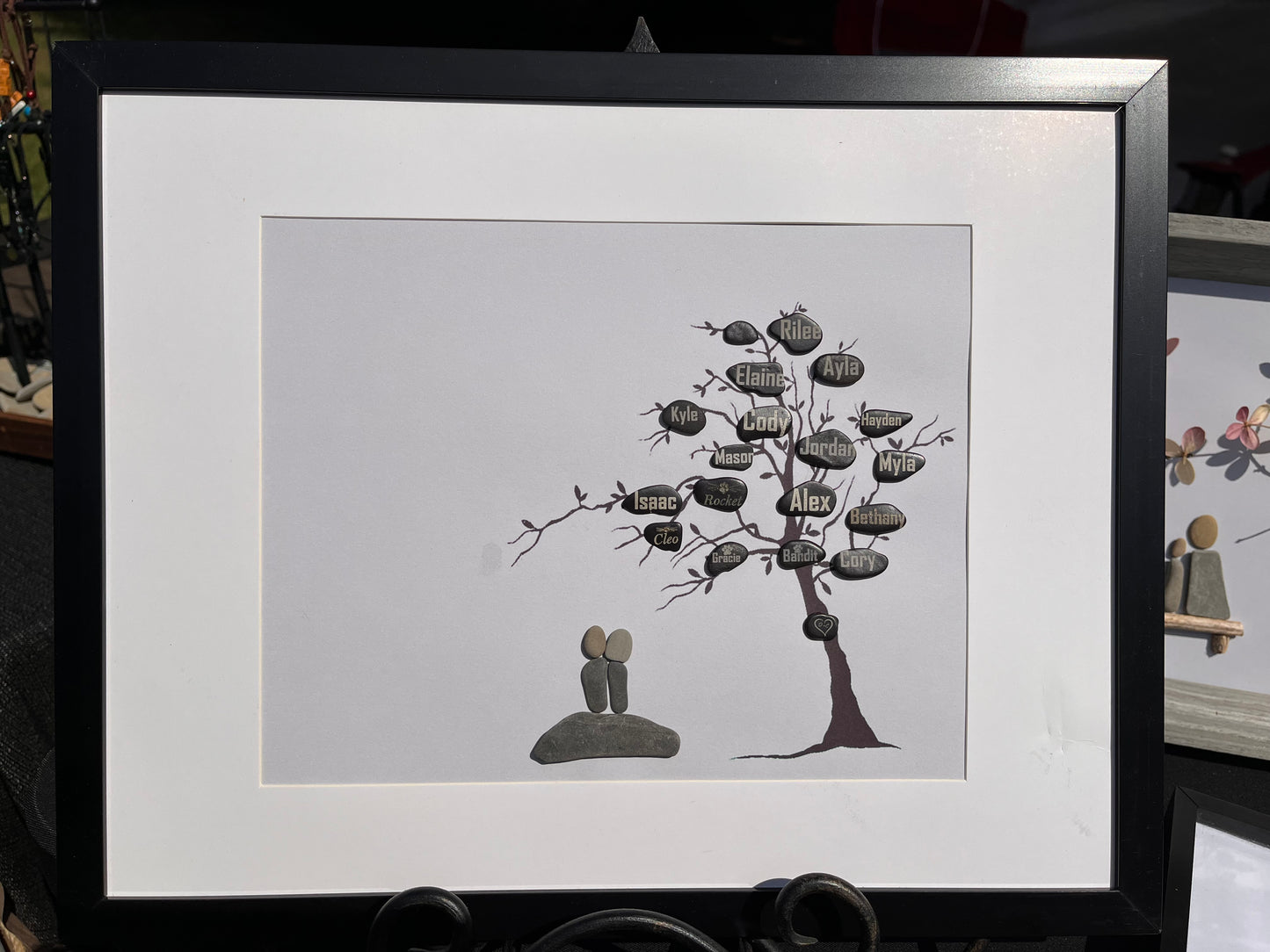 family tree keepsake customized with pebble couple and names of family laser marked on the leaves green leaves added and a foundation stone with couples wedding date . anniversary gift