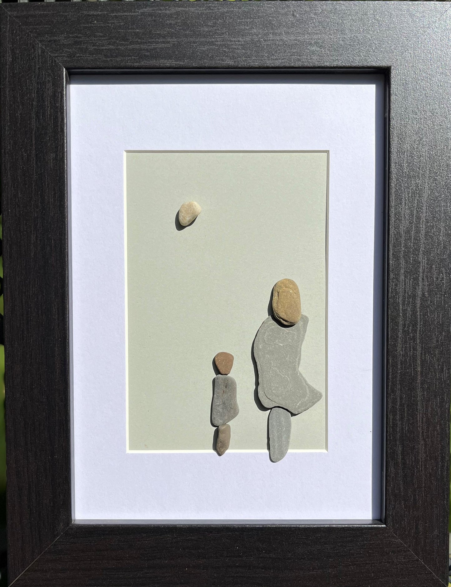 pebble art mother and son looking at the moon