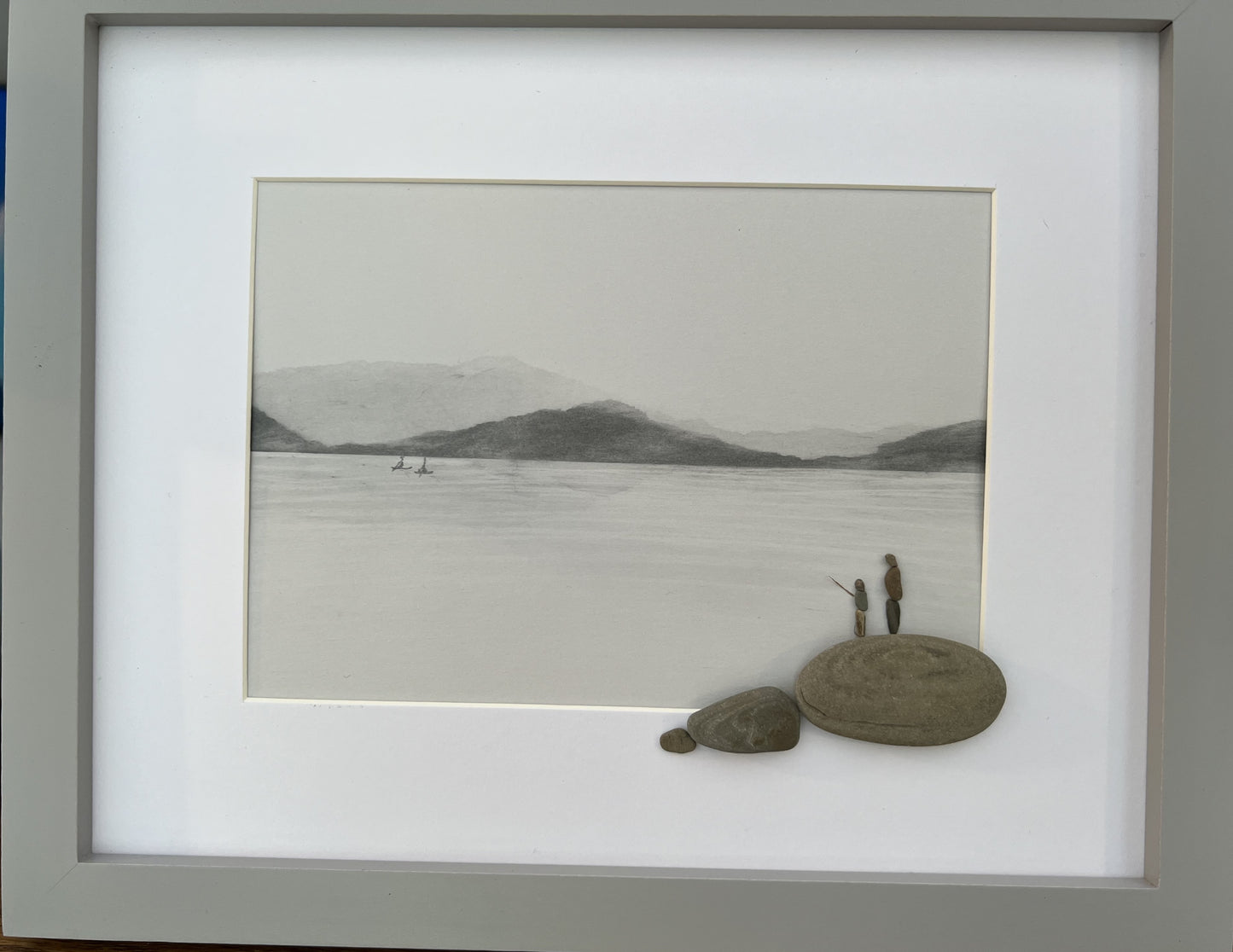 pebble art grandfather and grandson fishing on a lake