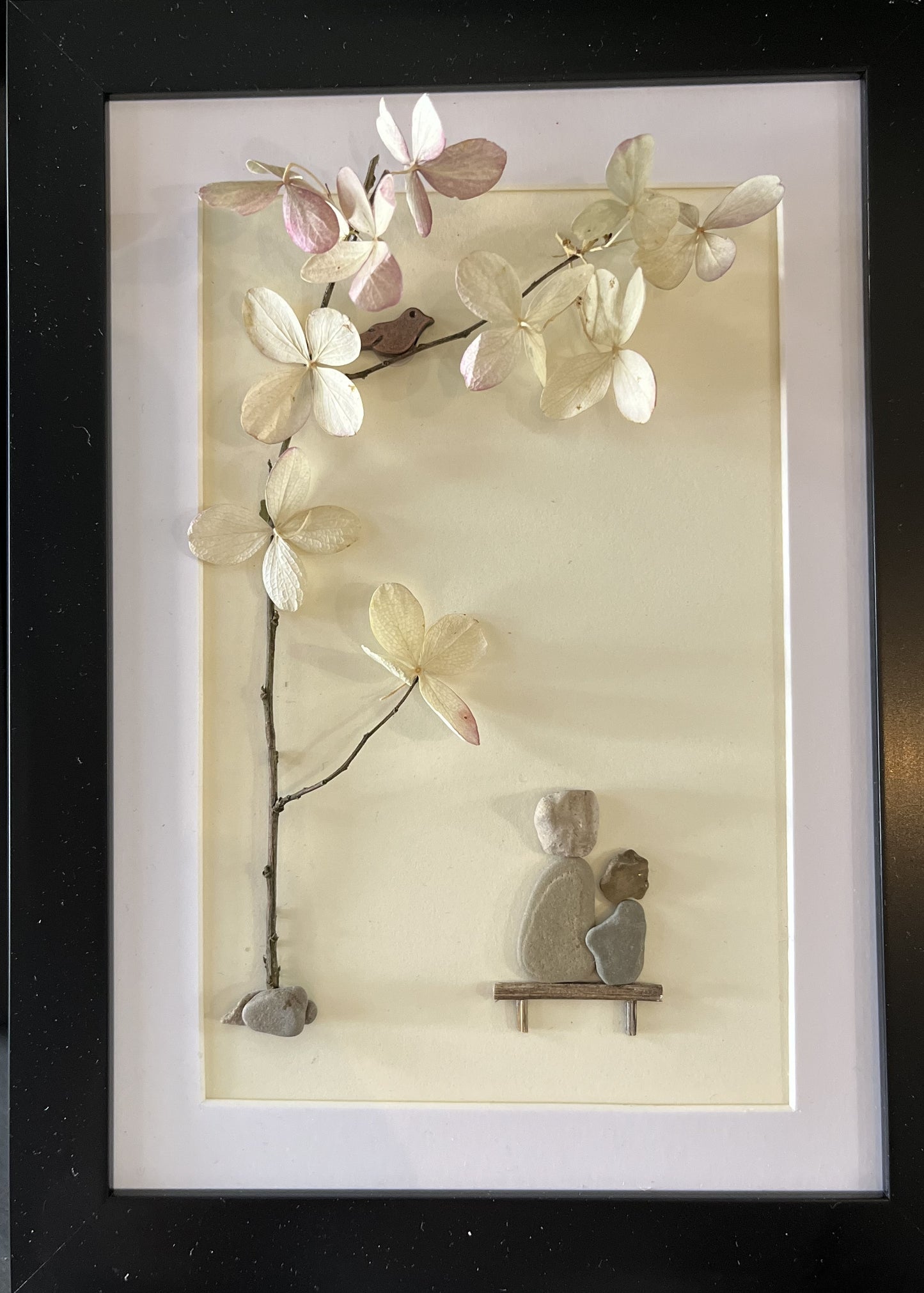 pebble art grandmother and grandson under a tree with flowers and bird